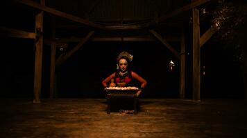 a female dancer sits gracefully and begins her ritual in front of beautiful offerings photo