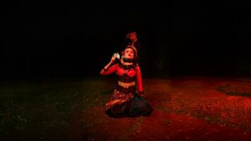 a group of female dancers with faces full of sadness sitting alone in the middle of a field photo