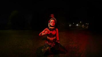 a group of female dancers with faces full of sadness sitting alone in the middle of a field photo