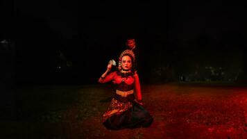 a group of female dancers with faces full of sadness sitting alone in the middle of a field photo