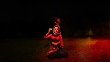 a group of female dancers with faces full of sadness sitting alone in the middle of a field photo