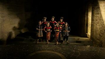 a group of dancers standing very proud and happy after finishing performing on stage photo