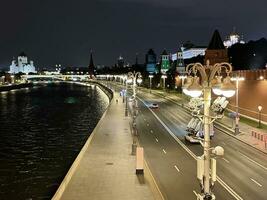 An ancient detail from an ancient bridge and the lights on a river photo