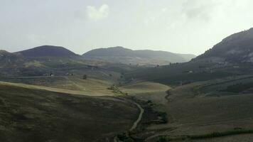 Top view or aerial shot of fresh green and yellow fields. Action. Top view of agricultural fields and mountains photo