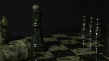 Black Queen in chess defeats white rock. Chess the queen wins victory over the game. Detail of chess piece on black background. Selective foucs photo
