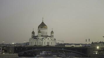 Aerial view of beautiful old cathedral building and Moscow river on sunset sky background. Action. Big churches with golden domes and the bridge, concept of architecture. photo