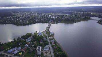 Top view of road across river in town. Clip. Beautiful landscape of city divided by strait with land highway. Highway connecting city strait on summer day photo