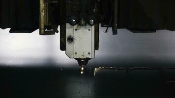 Laser machine cutting of sheet metal. Clip. Sparks fly from laser by automatic cutting CNC, PLC machine photo