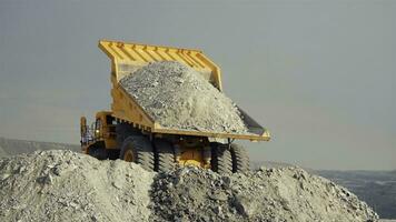 Mining loader unloads limestone ore or rock. View from the back. photo