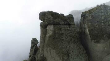 Aerial view on Mountains and rocks in fog. Shot. Foggy background with rocks photo