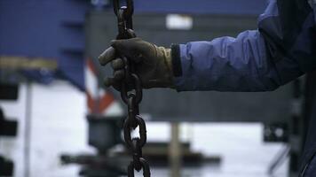 Worker touches the crane hooks to the loops during repair work. Clip. Worker keeps the chain of the crane photo
