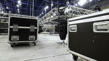 Installation of equipment and spotlights for stage. Stock footage. Preparing stage with bleachers and professional equipment and floodlights before performance or competition photo