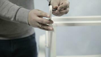 Man collects furniture in a workshop. Stock. Bonding and assembly of furniture on the wooden pins. photo