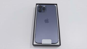 MOSCOW, RUSSIA-NOVEMBER, 2020. New iPhone model in box. Action. Latest iPhone model with stylish case and three cameras in package. New iPhone from Apple in package on white isolated background photo