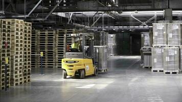 Fork lifter work in big warehouse. Clip. Warehouse man worker with forklift. Warehouse Rack of the Company photo