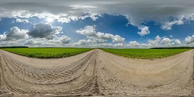 360 hdri panorama on gravel road with marks from car or tractor tires with clouds on blue sky in equirectangular spherical  seamless projection, skydome replacement in drone panoramas photo