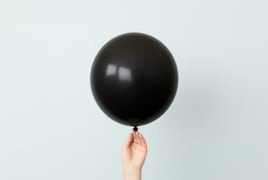 AI generated a person holds out a black balloon, photo