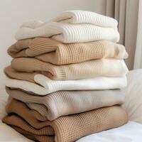 AI generated multiple colors of beige and white knitted sweaters photo