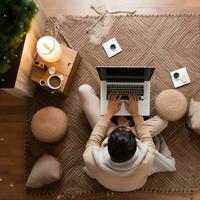 AI generated person sitting on foot on floor, on a laptop photo
