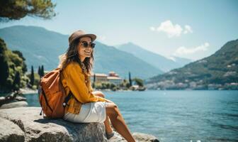 AI generated a woman sitting on the shore of lake como holding her backpack while smiling photo