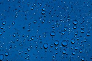 Water droplets on dark blue background photo