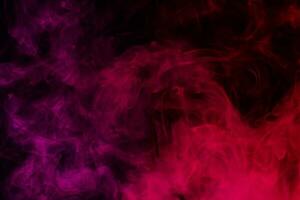 Colored smoke clouds flowing dark abstract background photo