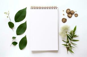 AI generated white background with empty notepad and green leaves around a white background photo