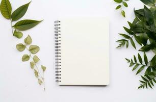 AI generated white background with empty notepad and green leaves around a white background photo