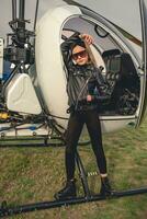 Full length portrait of tween girl in black near open helicopter photo
