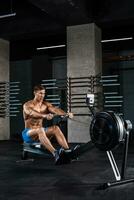 Bodybuilder working on his legs with weight machine at the gym photo