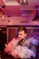 vapear vaping hombre en un nube de vapor. foto es tomado en un vape bar.