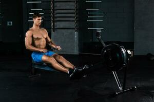 Muscular man doing exercise for legs in the gym photo