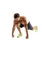 Sports young man doing push ups isolated on a white background photo