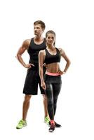 Sport, fitness, workout concept. Fit couple, strong muscular man and slim woman posing on a white background photo