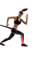 Woman exercising fitness resistance bands in studio silhouette isolated on white background photo