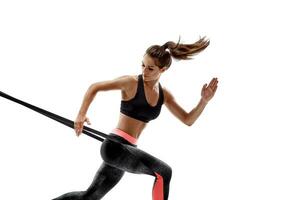 Woman exercising fitness resistance bands in studio silhouette isolated on white background photo