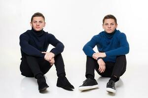 Casual twin brothers. Studio shoton a white background photo