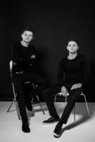 Casual twin brothers. Studio shot. Black and white photography photo