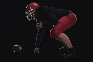 Football player on dark background photo