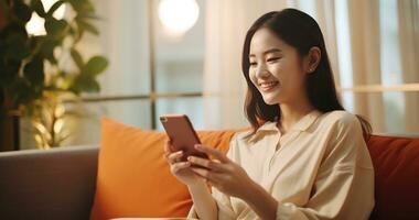 AI generated a chinese girl sits on a couch holding a smart phone while using her credit card photo