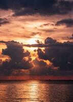 Sunset over tropical sea with colorful sky in cloudy and airplane photo