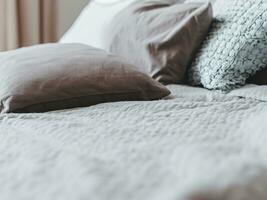 Closeup of flannel sheets and quilt on a bed photo