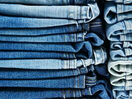 stack of blue jeans background photo