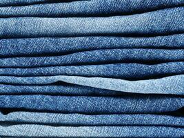 stack of blue jeans background photo