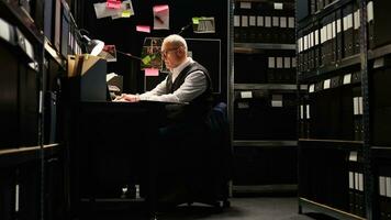 Private detective reading files, checking forensic evidence reports on classified documents in incident room. Law officer undertaking investigatory services with witness statements, uncover clues. photo