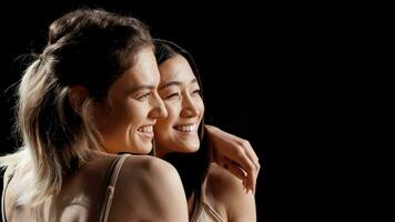Smiling women with different skintones and body types posing in skincare campaign, promoting body positivity, self confidence and self love. Interracial friends laughing and having fun. photo