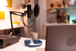 Online live podcast studio desk with microphone in home studio of vlogger. Influencer recording social media content with production microphone. Digital web internet streaming station photo