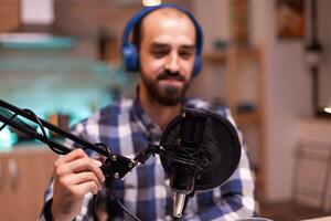 Using professional microphone for recording vlog in home studio. Creative online show On-air production internet broadcast host streaming live content, recording digital social media communication photo