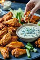 AI generated Delicious chicken wings with ranch dip and celery photo