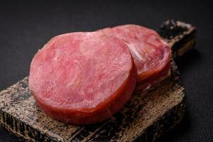 Round shape steaks of raw juicy tuna with salt and spices photo